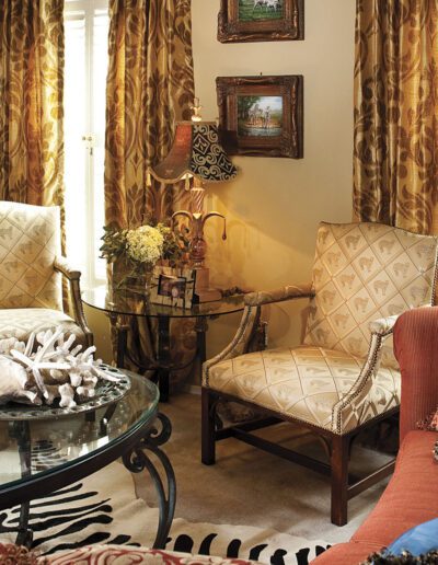 A living room with zebra print curtains.