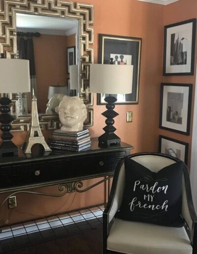 A black and white console table with a black and white eiffel tower pillow.